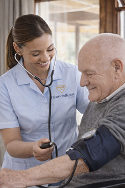 home nurse checking blood pressure elderly