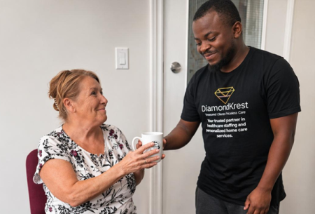 male caregiver helping elderly woman
